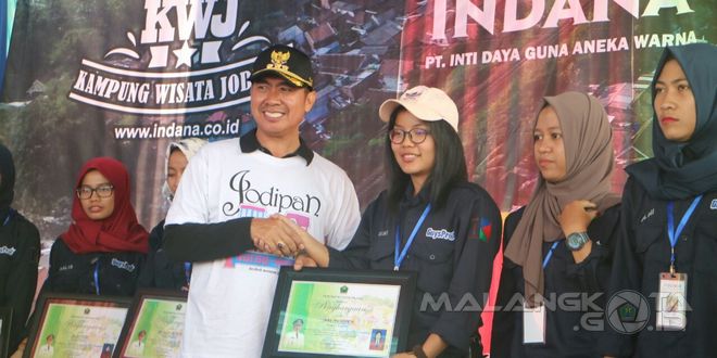 Walikota Malang H. Moch. Anton memberikan piagam penghargaan kepada para mahasiswa UMM selaku penggagas Kampung Warna Warni